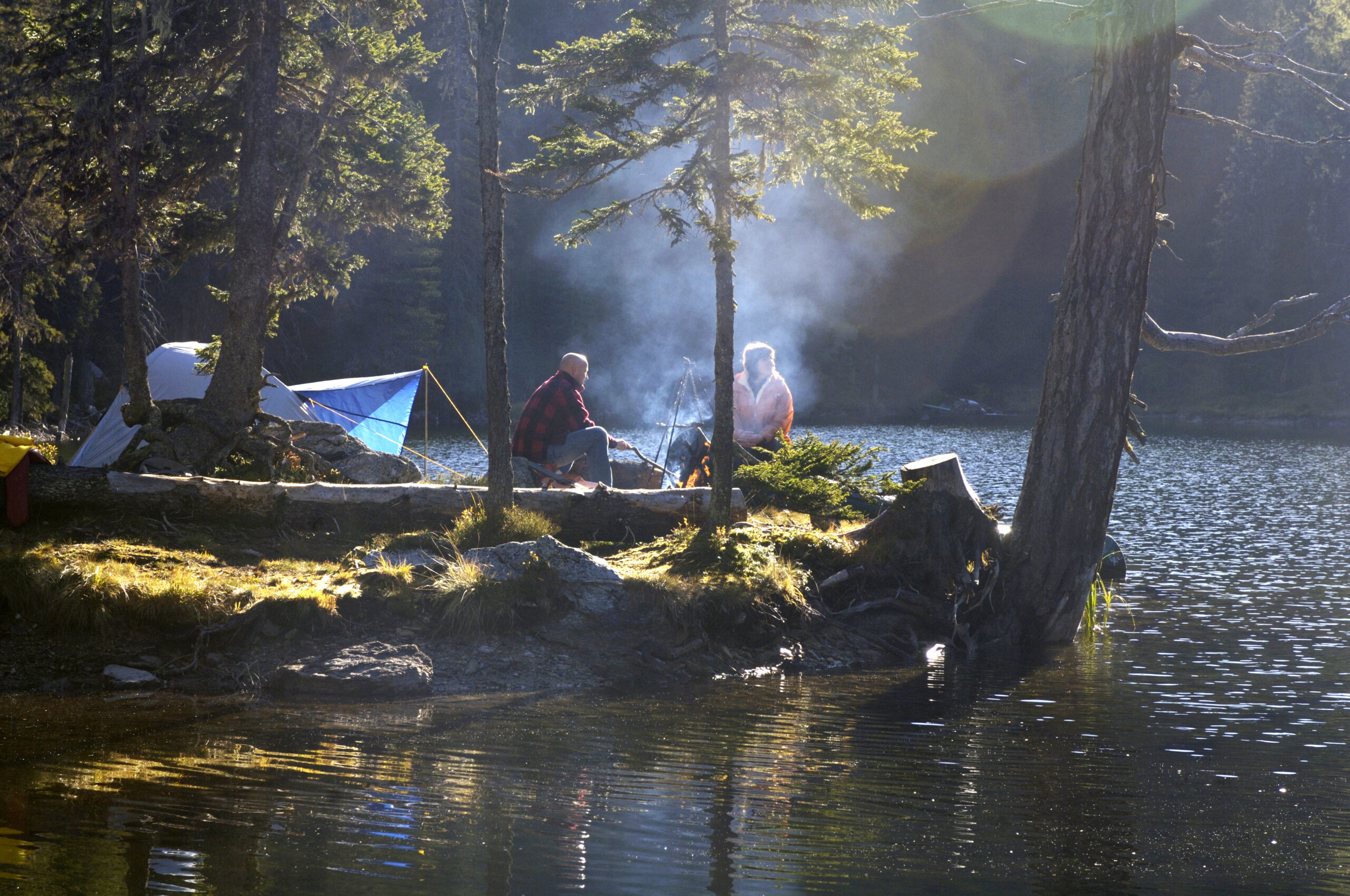 Man and woman camping on small island
